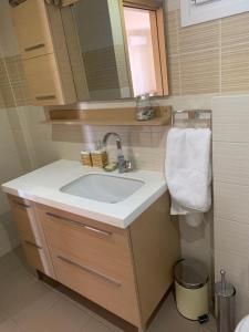 a bathroom with a sink and a mirror at Breathtaking sea view in Kavala