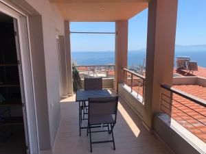 a balcony with a table and chairs on it at Breathtaking sea view in Kavála