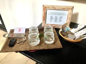 a table with glasses and a basket on it at la Tour d'Héloïse - 10' de Bruxelles in La Hulpe