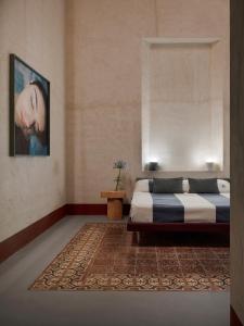 a bedroom with a bed and a rug at LABottega - Camere in Marina di Pietrasanta