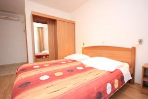 a bedroom with a large wooden bed in a room at Double Room Zaglav 8144b in Zaglav