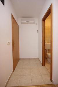 a hallway of a bathroom with a toilet and a door at Double Room Zaglav 8144b in Zaglav