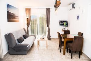 a living room with a couch and a table at Apartment Sea&Sky in Tivat