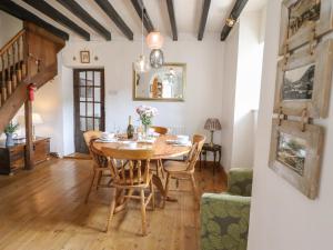 a dining room with a wooden table and chairs at Minafon in Oswestry