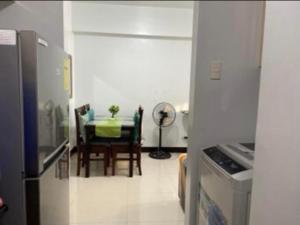 a kitchen with a table and a dining room at F-10C Parkside Villas in Manila