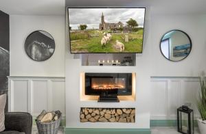 a living room with a fireplace and a mirror at Curragh House in Kinsale