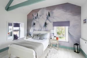 a bedroom with a bed and a painting of giraffes at Curragh House in Kinsale