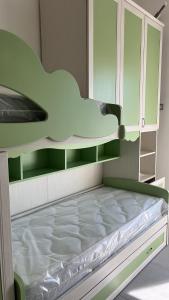 a bedroom with a bunk bed with a white bed frame at Le zagare in Palagiano