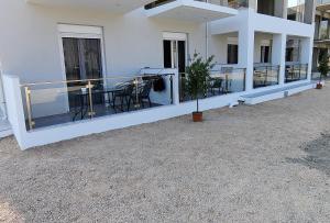 a balcony of a building with a table and chairs at CONMARI LUXURY STUDIOS in Nydri