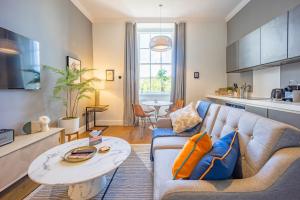 a living room with a couch and a table at No1 Apartments Edinburgh - George IV Bridge in Edinburgh