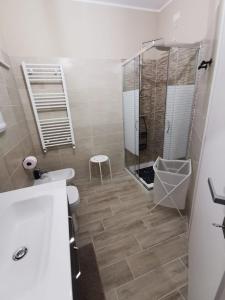 a bathroom with a shower and a toilet and a sink at Il Piacere in Pineto +12 photos