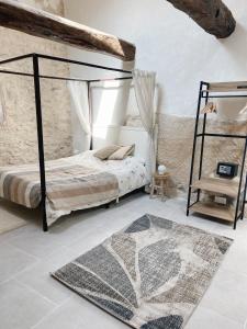 a bedroom with a bed with a metal bed frame at Bonnieux : Loft - La pause in Bonnieux