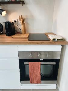 a kitchen counter with a stove with a towel on it at Bonnieux : Loft - La pause in Bonnieux