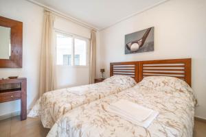 a bedroom with two beds and a table and a window at Lovely Apartment with Wrap Around Terrace Golf Views - AO1713LT in Torre-Pacheco