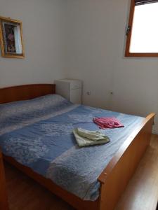 a bedroom with a bed with two towels on it at Apartments Igor in Žabljak