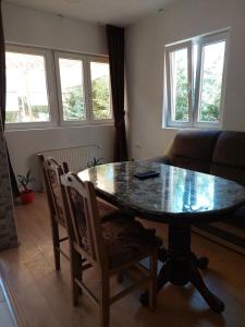 a dining room table and chairs in a living room at Apartments Igor in Žabljak