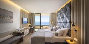 a hotel room with a bed with a view of the ocean at Aminess Khalani Hotel in Makarska