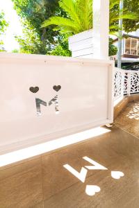 a white fence with a dog decal on it at Mantovani Hotel Murano & Mariù in Rimini