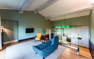 a living room with a blue couch and a table at La Terrazza Sull'Arno in Florence