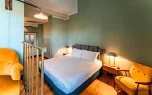 a small bedroom with a bed and a chair at La Terrazza Sull'Arno in Florence