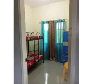 a room with two bunk beds and a shower at Sunrise Enterprise in Tagum