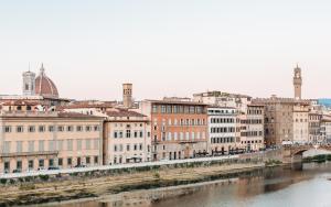 a view of a city with a river and buildings at La Terrazza Sull'Arno in Florence