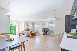 a kitchen and living room with a table and chairs at La Rose in Gillingham