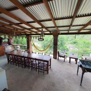 comedor grande con mesa grande y bancos en Casa Filomena, en Villa Canada del Sauce 7 fotos más