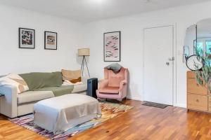 a living room with a couch and a chair at Bright 1 Bedroom Apartment in Lane Cove in Sydney