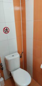 a bathroom with a toilet with a sign on the wall at Villa Ilios in Olympiaki Akti