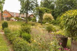 a garden in front of a house with flowers at Manderley in Arceau