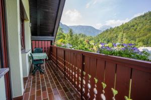 a balcony with a view of flowers and mountains at Apartments Bohinj Mavrica in Bohinj