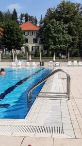 - une piscine avec des chaises et une personne dans l'établissement VILLA GOLF Crystal Drop Apartment, à Rogaška Slatina