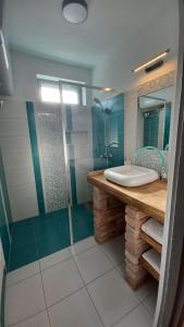 a bathroom with a glass shower and a sink at Panna Cottage in Badacsonytomaj