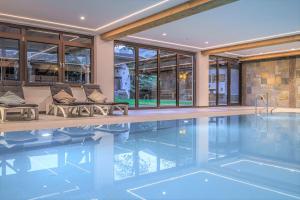 an indoor swimming pool in a house with at Almhof Lackner in Ried im Zillertal