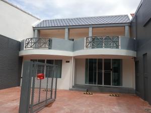 a house with a gate in front of it at Cha-am Beach Vacation Home in Cha Am