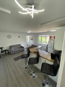 a kitchen and living room with a table and chairs at Monochrome 16 , Brentwood in Brentwood