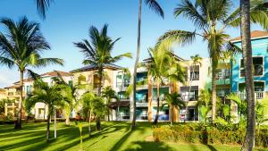 a resort with palm trees in front of it at Ocean Blue & Sand Beach Resort - All Inclusive in Punta Cana