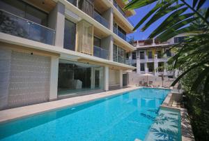 a swimming pool in front of a building at Apartment in Aonang - great location with pool in Ao Nang Beach