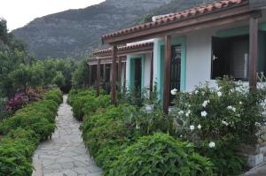 einen Weg zu einem Haus mit Blumen in der Unterkunft ΤΟΥΡΙΣΤΙΚΕΣ ΕΠΙΠΛΩΜΕΝΕΣ ΚΑΤΟΙΚΙΕΣ φροσω χωριατη in Agios Kirykos
