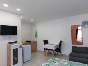 A television and/or entertainment centre at AMORE house with apartment