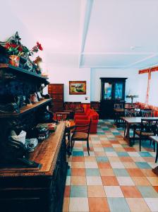 - un salon avec une cheminée, des tables et des chaises dans l'établissement IHR Hotel Villa Emma, à Canazei