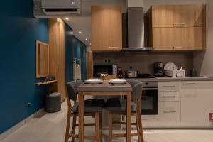 a kitchen with a wooden table and chairs at Centro Apartments in Heraklio Town