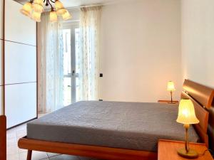 a bedroom with a bed and a window at Sunset Boutique Apartment in Marina di Massa