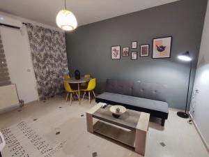 a living room with a couch and a table at EM.MA HOME in Heraklio