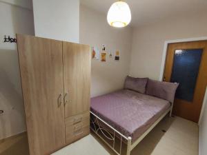 a small room with a bed and a cabinet at EM.MA HOME in Heraklio +5 photos