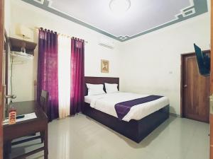 Tempat tidur dalam kamar di Hotel Manggala Syariah