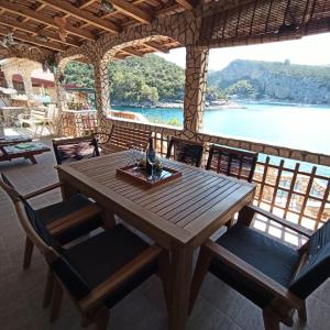 a wooden table and chairs with a view of the water at Holiday Home Jelena in Zastražišće