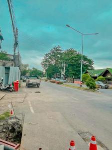 a street with a truck driving down the street at Taweehome hotel in Phra Nakhon Si Ayutthaya