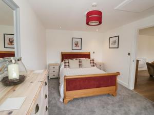 a bedroom with a bed and a desk at The Goose Nest in Worcester